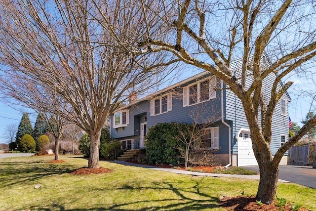 50 Hillside Rd, Tewksbury, MA 01876 - view of front facade with an attached garage, a front yard, driveway, and a chimney