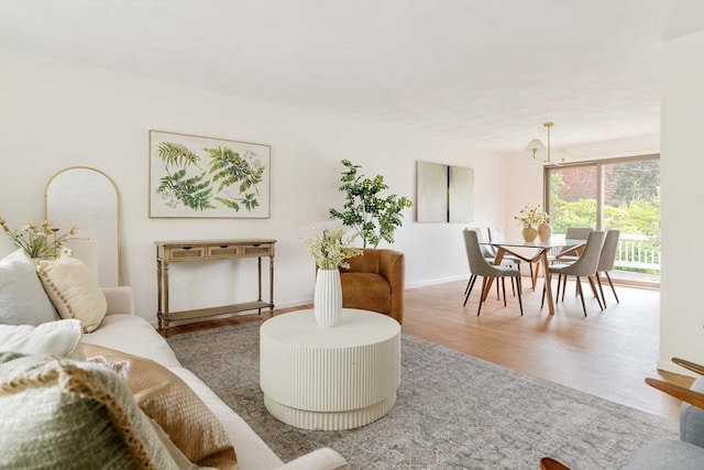 50 Hillside Rd, Tewksbury, MA 01876 - living room with a chandelier, wood finished floors, and baseboards
