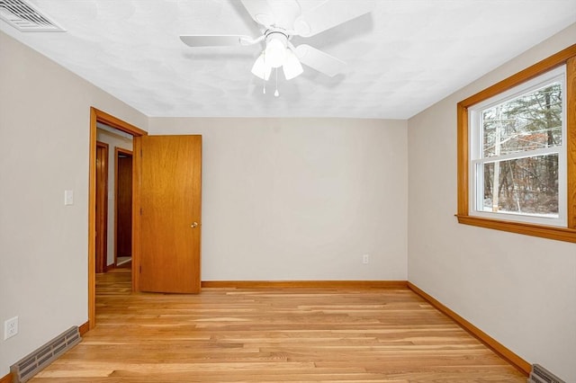 unfurnished room with ceiling fan and light hardwood / wood-style floors