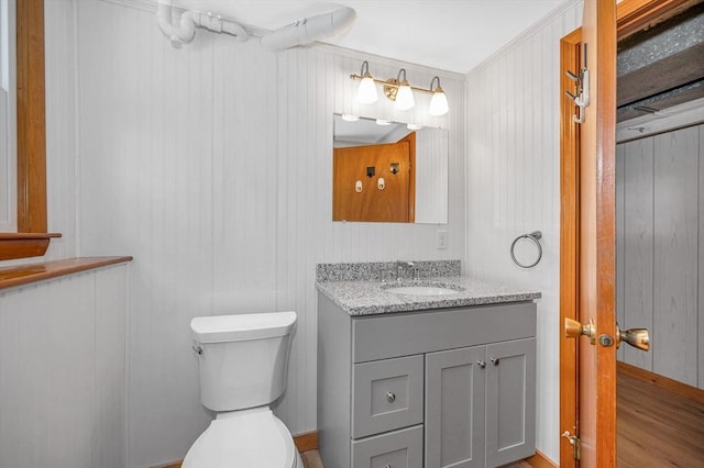 bathroom featuring vanity, hardwood / wood-style flooring, and toilet