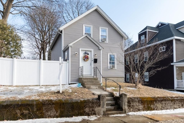 view of front of home featuring fence