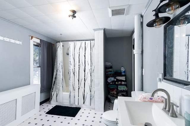 full bathroom featuring toilet, vanity, and shower / bath combo with shower curtain