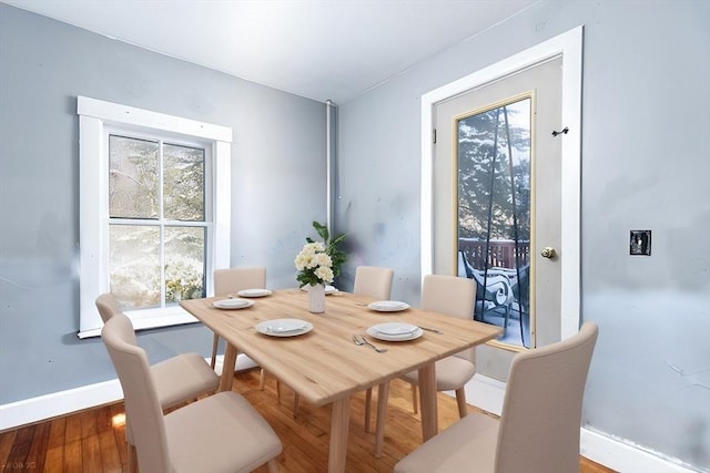 dining space with hardwood / wood-style flooring