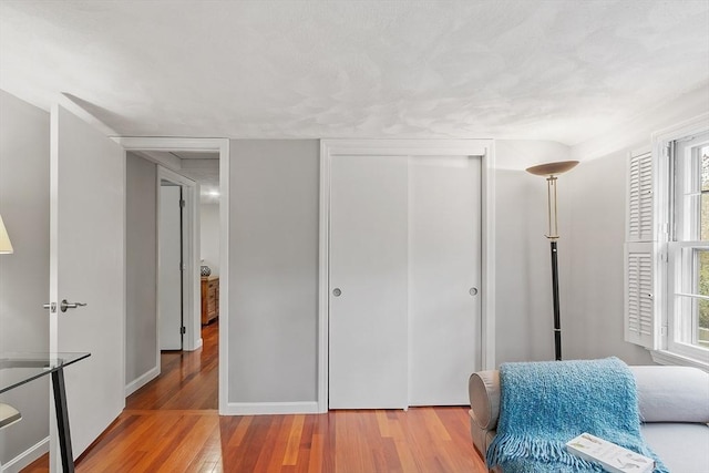 living area with wood finished floors and baseboards