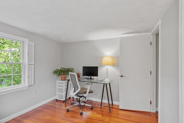home office featuring wood finished floors and baseboards