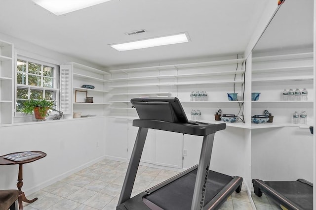 workout room featuring light tile patterned floors
