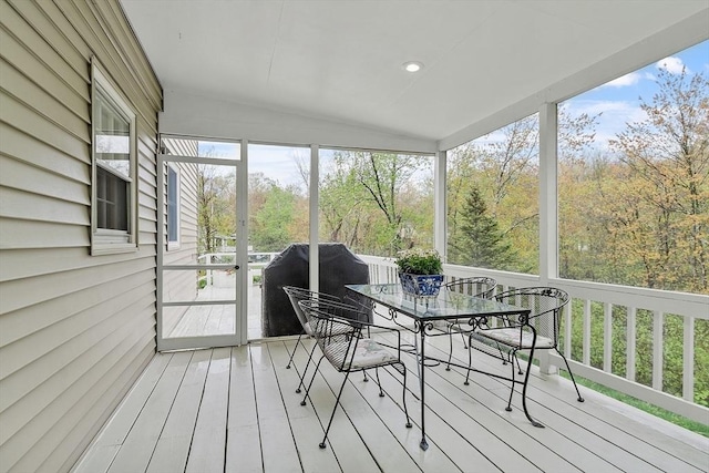sunroom / solarium with outdoor dining space and lofted ceiling