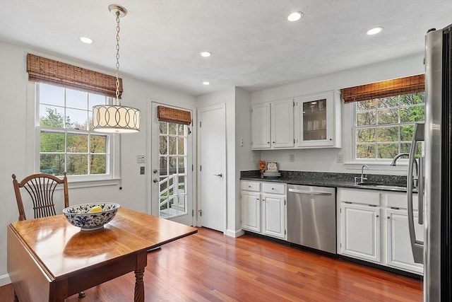 kitchen featuring dishwasher, white cabinets, healthy amount of natural light, dark wood finished floors, and recessed lighting