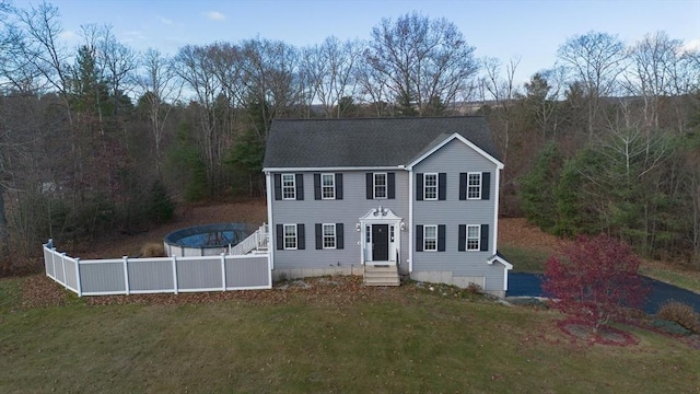 colonial home with a front lawn