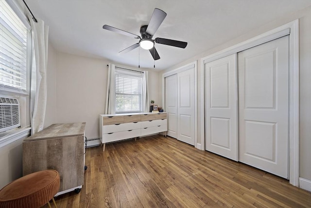 45 Weyham Rd, Weymouth, MA 02191 - bedroom featuring multiple closets, dark wood finished floors, ceiling fan, and baseboard heating