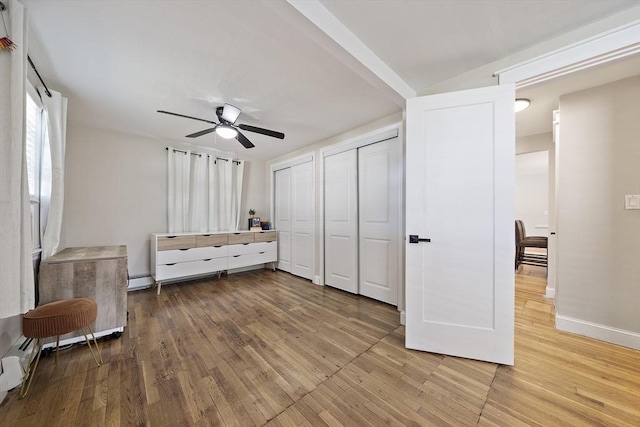 45 Weyham Rd, Weymouth, MA 02191 - bedroom featuring multiple closets, light wood-style flooring, baseboards, and a ceiling fan