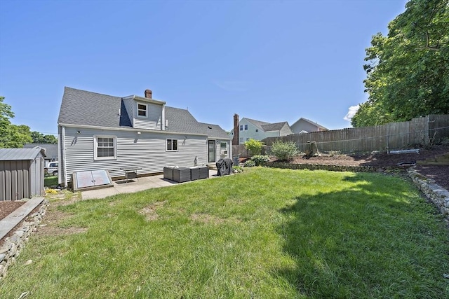 45 Weyham Rd, Weymouth, MA 02191 - rear view of house with outdoor lounge area, a patio area, a chimney, and an outbuilding