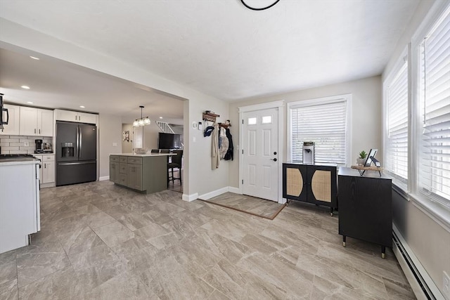 45 Weyham Rd, Weymouth, MA 02191 - entrance foyer featuring baseboard heating, baseboards, a chandelier, and light marble finish flooring
