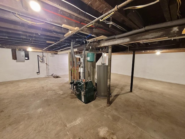 basement featuring electric panel and water heater