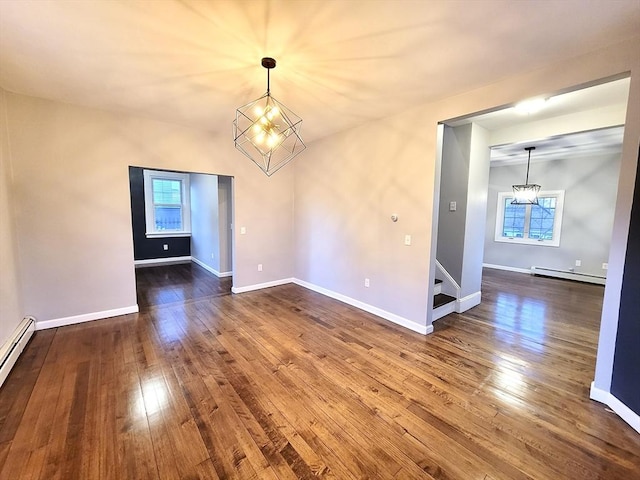 unfurnished dining area with a healthy amount of sunlight, hardwood / wood-style flooring, baseboard heating, and a notable chandelier