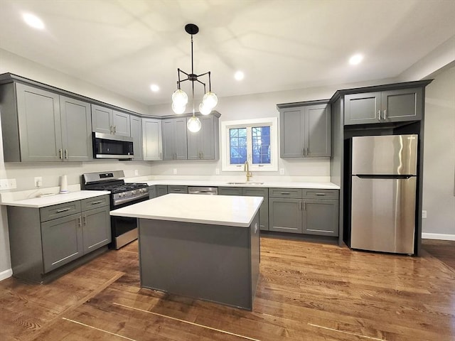 kitchen with appliances with stainless steel finishes, gray cabinets, and sink