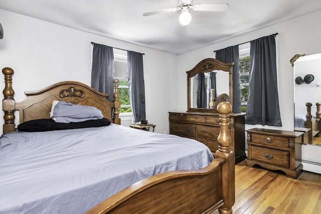 bedroom with light wood finished floors and a ceiling fan