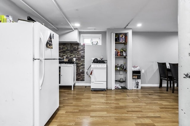 kitchen featuring white appliances, light wood-style flooring, white cabinetry, and recessed lighting