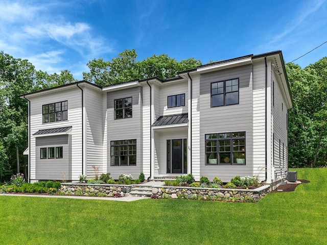 view of front of house featuring central AC and a front lawn