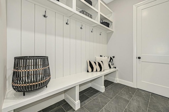 mudroom with dark tile patterned flooring