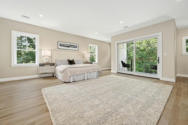 bedroom with access to exterior and light wood-type flooring