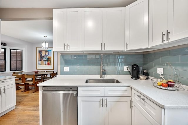 30 Howard St, Cambridge, MA 02139 - kitchen with stainless steel dishwasher, a sink, white cabinetry, and light wood-type flooring
