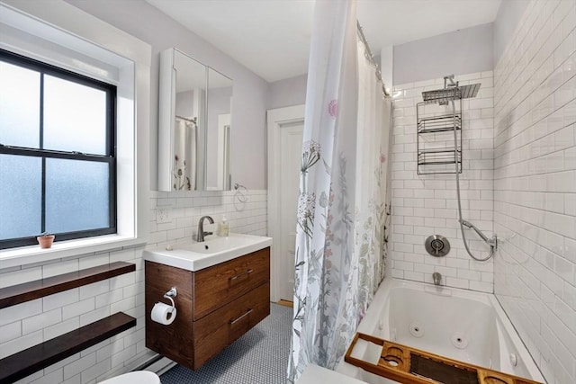 30 Howard St, Cambridge, MA 02139 - full bath featuring healthy amount of natural light, a combined bath / shower with jetted tub, vanity, and decorative backsplash