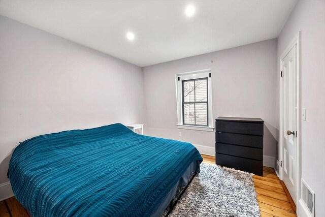 30 Howard St, Cambridge, MA 02139 - bedroom with wood finished floors, recessed lighting, and baseboards
