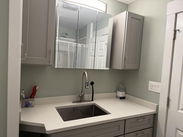 30 Howard St, Cambridge, MA 02139 - kitchen featuring gray cabinetry, a sink, and light countertops