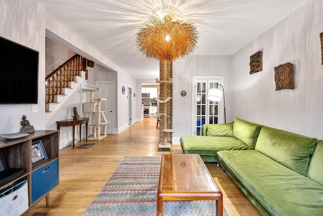 30 Howard St, Cambridge, MA 02139 - living area featuring stairway, light wood finished floors, french doors, and baseboards