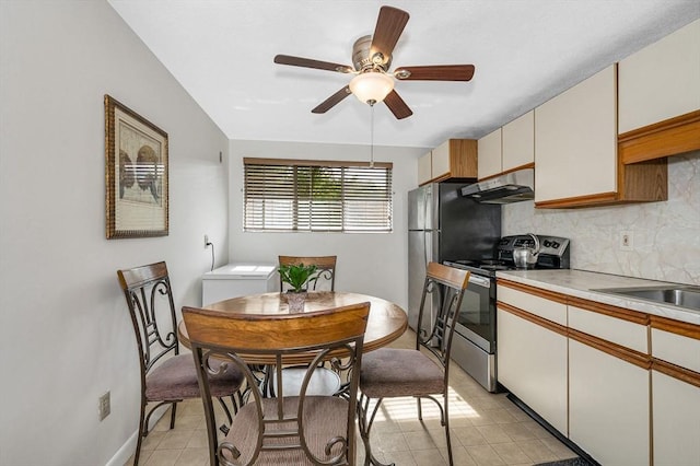 10 Woodcrest Ct Unit 6, Weymouth, MA 02190 - kitchen with stainless steel appliances, under cabinet range hood, decorative backsplash, light countertops, and light tile patterned floors