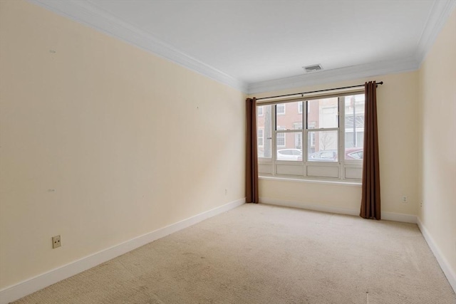 empty room featuring light carpet, baseboards, and crown molding