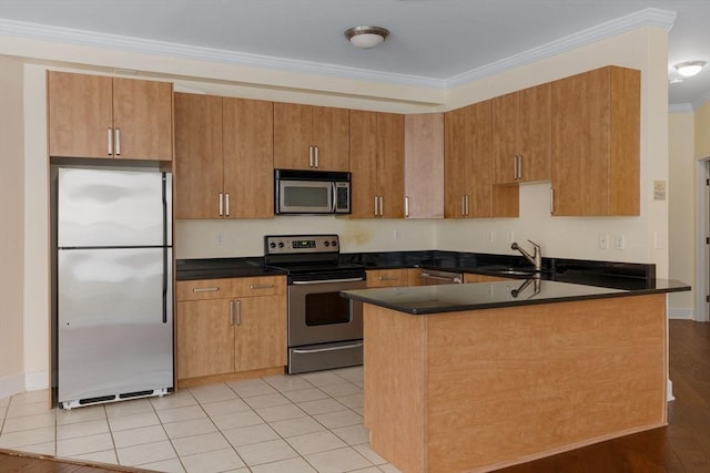 kitchen featuring dark countertops, appliances with stainless steel finishes, a sink, and ornamental molding