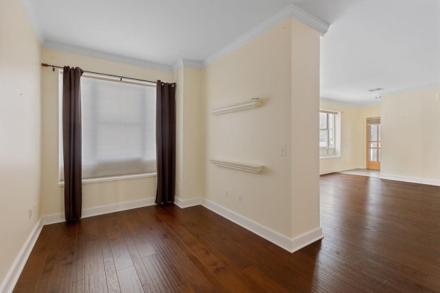 unfurnished room with dark wood-style floors, ornamental molding, and baseboards