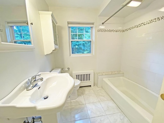 full bathroom with a wealth of natural light, a sink, bathing tub / shower combination, and toilet