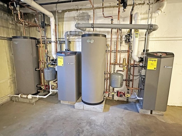 utility room featuring water heater and a heating unit