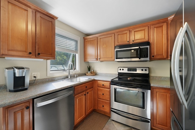 kitchen featuring sink, light tile patterned floors, and stainless steel appliances