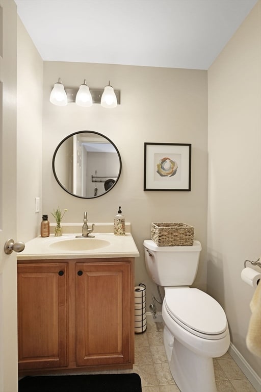 bathroom featuring tile patterned floors, toilet, and vanity