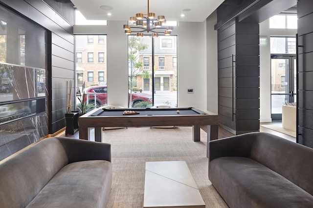 rec room with a chandelier and billiards