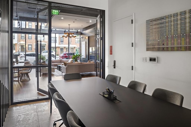 dining space featuring a chandelier and expansive windows