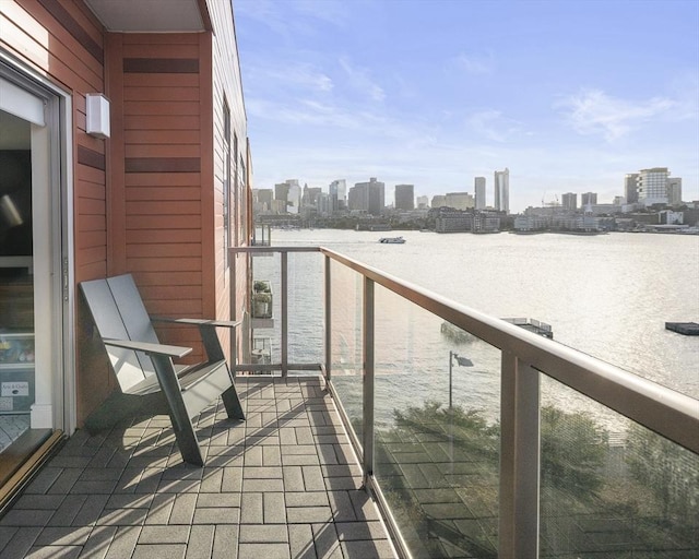 balcony featuring a view of city and a water view