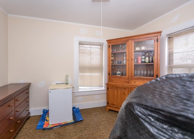 bedroom featuring dark colored carpet, ornamental molding, and baseboards