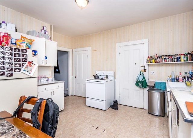 kitchen featuring open shelves, white appliances, light countertops, and wallpapered walls