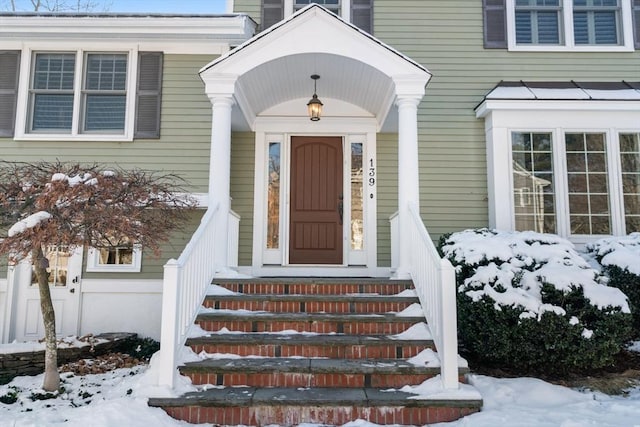 view of snow covered property entrance