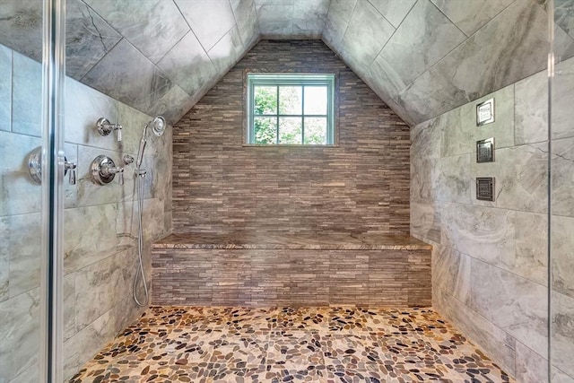 full bathroom with a shower stall and vaulted ceiling