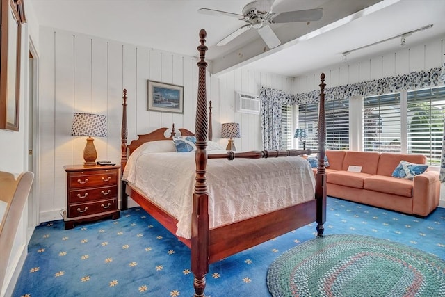 bedroom featuring carpet floors, rail lighting, a ceiling fan, and a wall mounted air conditioner