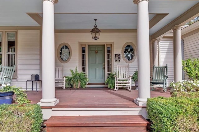 view of exterior entry featuring covered porch