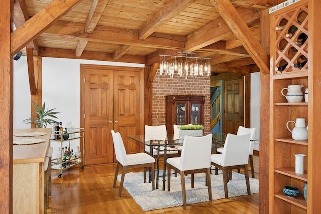 1292 Main St, Lancaster, MA 01523 - dining space with wood finished floors, a wooden ceiling with exposed beams, a chandelier, and built in features