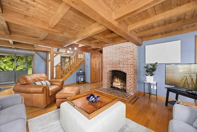 1292 Main St, Lancaster, MA 01523 - living room featuring a wooden ceiling with exposed beams, hardwood / wood-style floors, a fireplace, and stairs