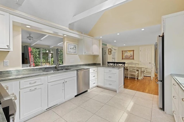 4 Wildwood Ave, Harwich, MA 02645 - kitchen featuring stainless steel appliances, white cabinetry, a peninsula, recessed lighting, and light tile patterned floors